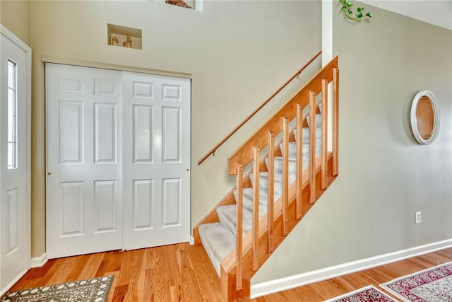 stairs featuring baseboards and wood finished floors