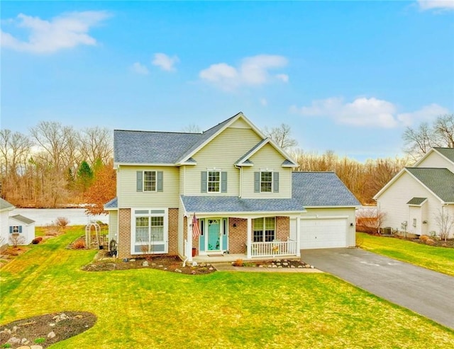 traditional home featuring brick siding, a front lawn, aphalt driveway, a porch, and a garage