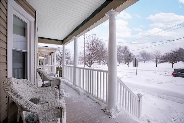 view of snow covered back of property