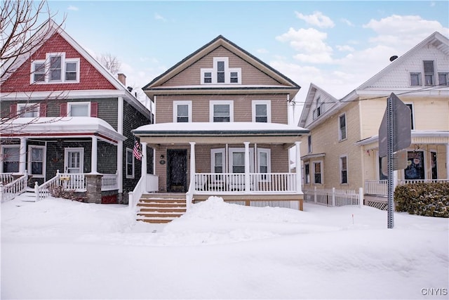 american foursquare style home with a porch