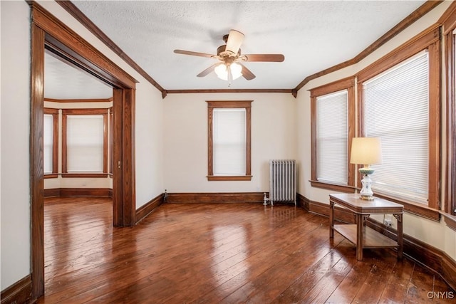 37 Niagara St, Oswego-City, NY 13126 - empty room featuring hardwood / wood-style floors, radiator heating unit, crown molding, and baseboards