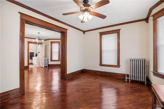 unfurnished room with radiator, crown molding, and hardwood / wood-style flooring