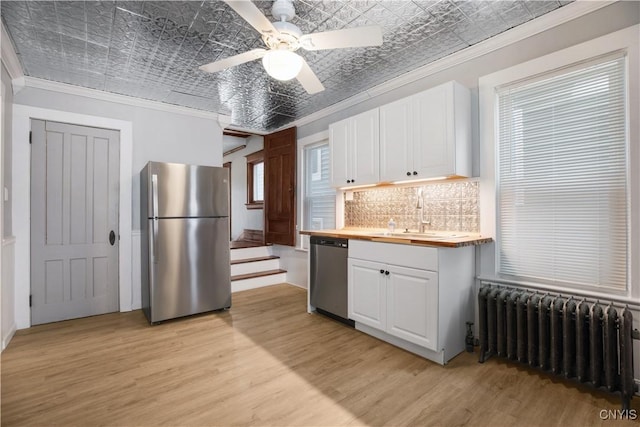 37 Niagara St, Oswego-City, NY 13126 - kitchen with crown molding, a sink, stainless steel appliances, radiator, and an ornate ceiling
