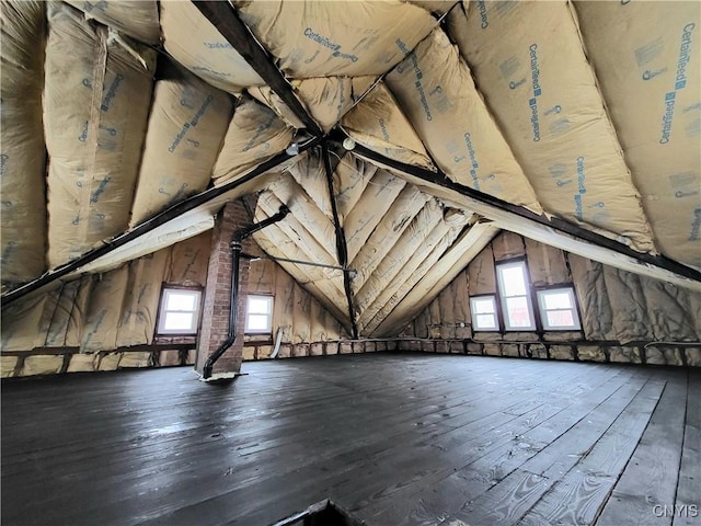 additional living space featuring vaulted ceiling and hardwood / wood-style flooring