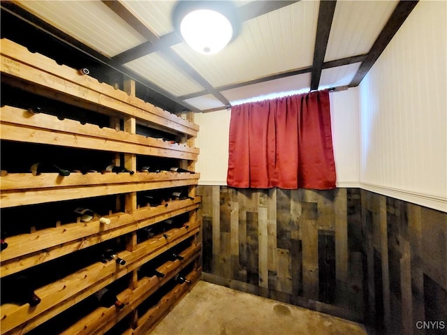 wine cellar with wooden walls and unfinished concrete floors