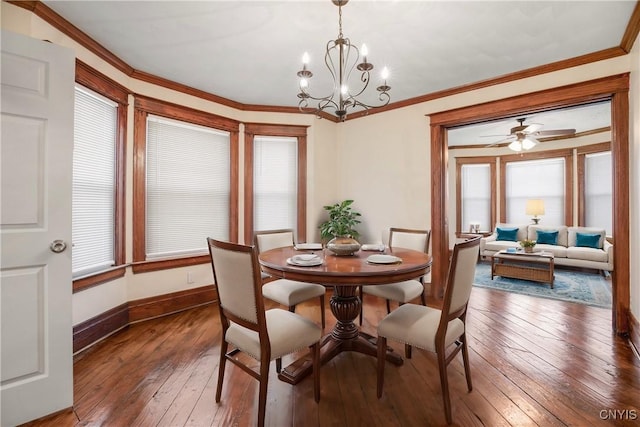 dining area featuring an inviting chandelier, baseboards, wood-type flooring, and ornamental molding