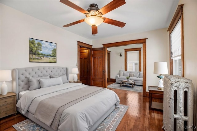 bedroom featuring baseboards, dark wood-style floors, and a ceiling fan