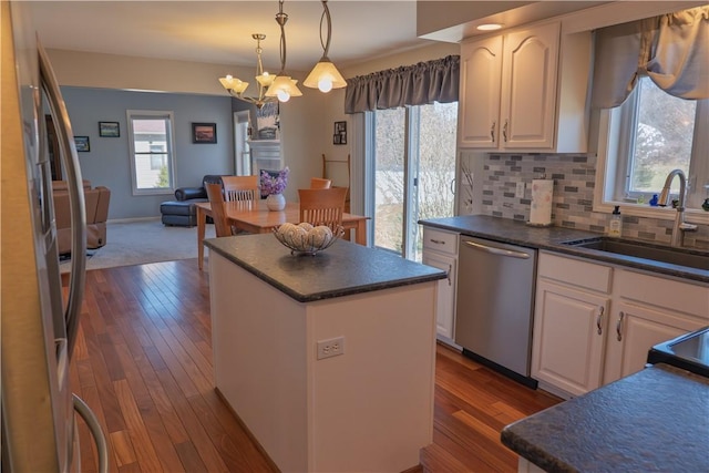 kitchen with dark countertops, a center island, and stainless steel appliances