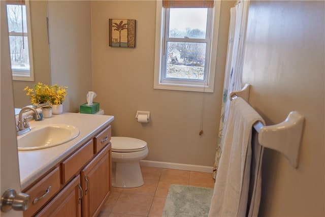 bathroom with tile patterned floors, toilet, vanity, and baseboards