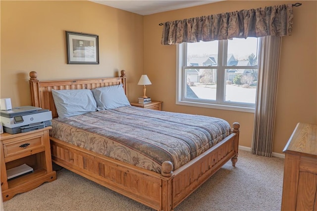 bedroom featuring baseboards and light carpet