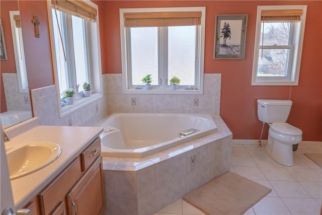 bathroom featuring toilet, tile patterned floors, plenty of natural light, and a garden tub