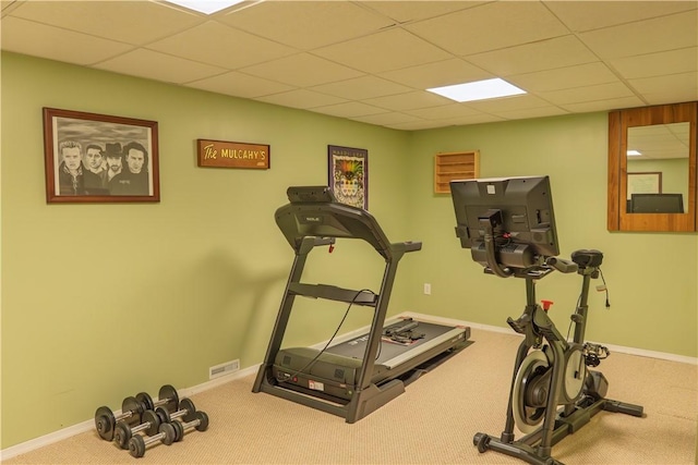 workout area with carpet flooring, a paneled ceiling, and baseboards