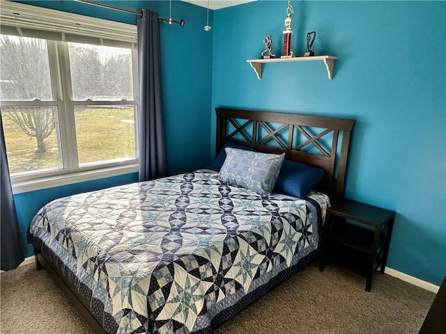 bedroom with carpet flooring, multiple windows, and baseboards