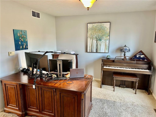 carpeted office space featuring visible vents and baseboards