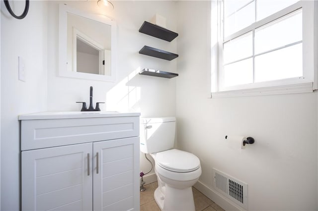 bathroom with vanity, toilet, visible vents, and tile patterned flooring