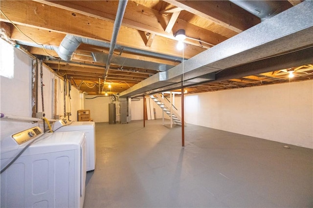 unfinished basement with stairs, gas water heater, and independent washer and dryer