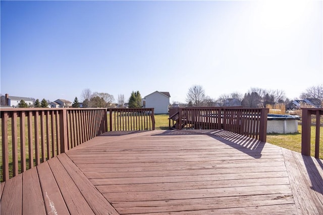 deck with a yard and a covered pool