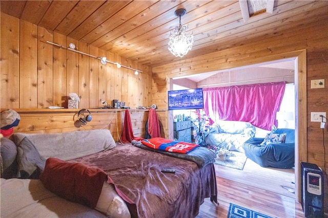 bedroom featuring wood finished floors, wood walls, and wooden ceiling