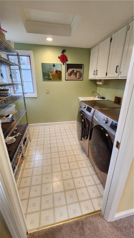 laundry area featuring baseboards, cabinet space, and independent washer and dryer