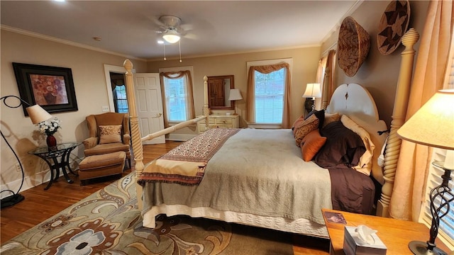 bedroom with ceiling fan, wood finished floors, and ornamental molding