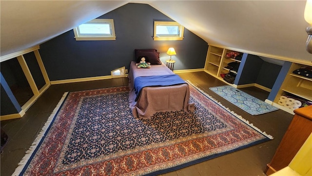 bedroom featuring baseboards, lofted ceiling, and wood finished floors