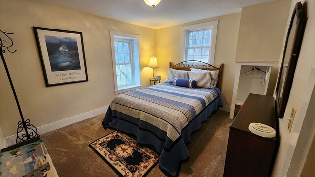 carpeted bedroom featuring baseboards and multiple windows