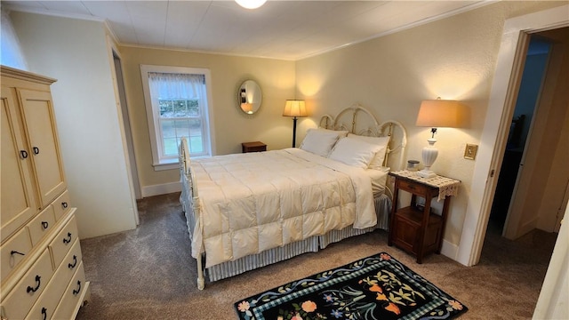 bedroom with baseboards, dark colored carpet, and ornamental molding