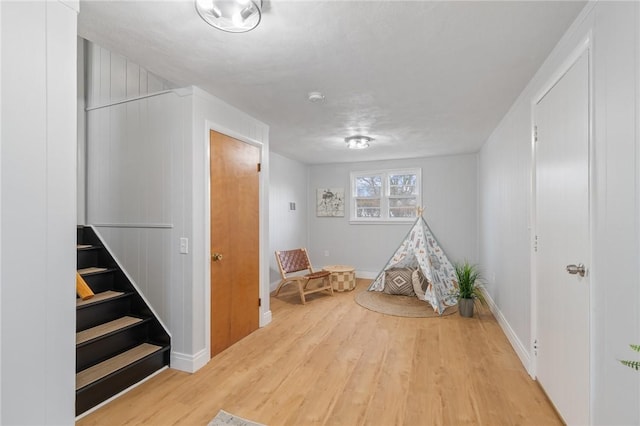 rec room with wood finished floors and baseboards