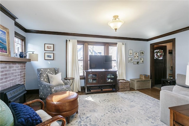 living area featuring a wealth of natural light, a brick fireplace, wood finished floors, and crown molding