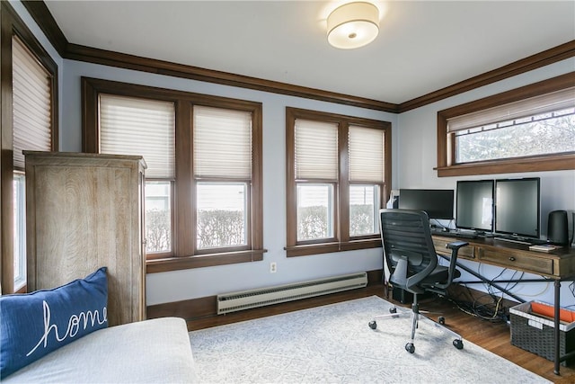 office area featuring a baseboard heating unit, plenty of natural light, wood finished floors, and crown molding