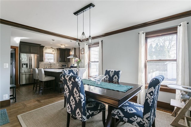 dining area with baseboards, dark wood-style flooring, and ornamental molding