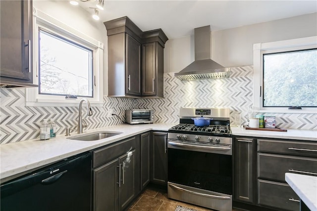 kitchen featuring a sink, stainless steel gas range oven, dishwasher, wall chimney exhaust hood, and backsplash