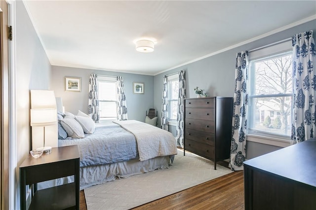 bedroom featuring dark wood-style flooring and crown molding