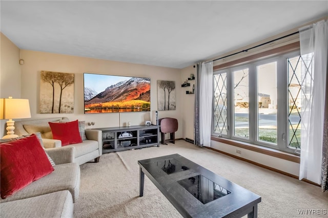 living area featuring carpet flooring and baseboards