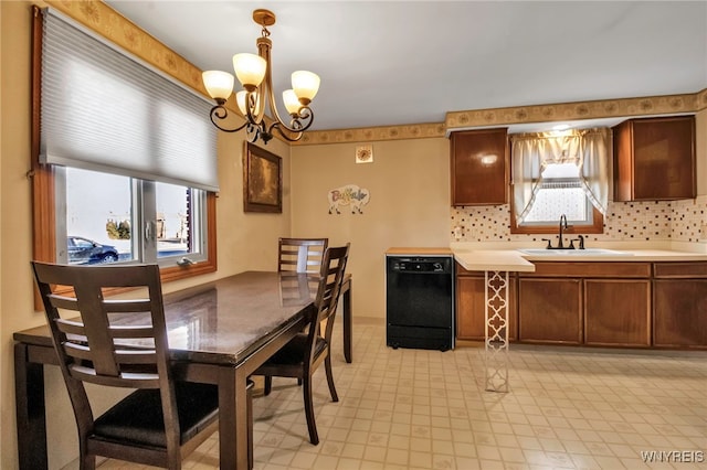 kitchen featuring dishwasher, light countertops, tasteful backsplash, and a sink