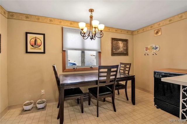 dining space featuring a notable chandelier and baseboards