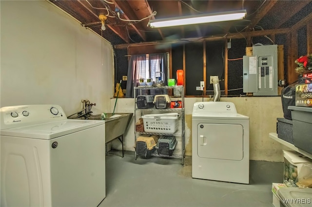 laundry area with a sink, laundry area, electric panel, and washing machine and clothes dryer