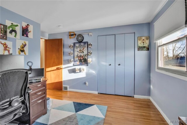 office space with visible vents, baseboards, and wood finished floors