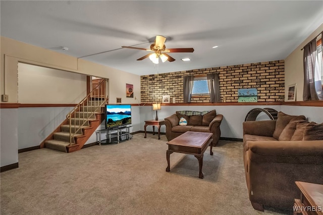 living room with stairway, baseboards, ceiling fan, and carpet floors