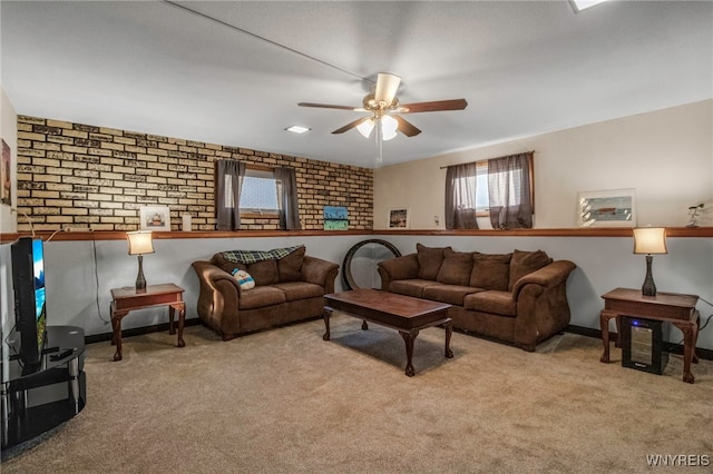 carpeted living room with baseboards and ceiling fan