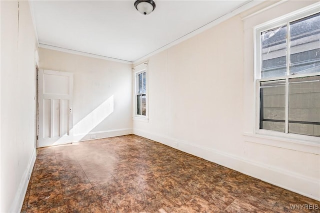 spare room featuring baseboards and ornamental molding