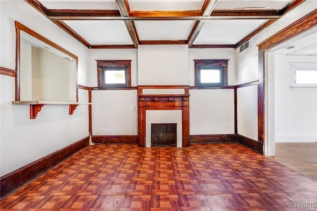 unfurnished living room with a fireplace, visible vents, coffered ceiling, and baseboards