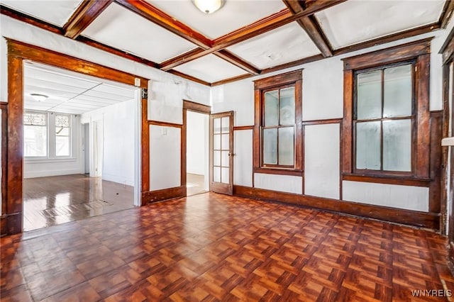 unfurnished room with beamed ceiling, coffered ceiling, and baseboards