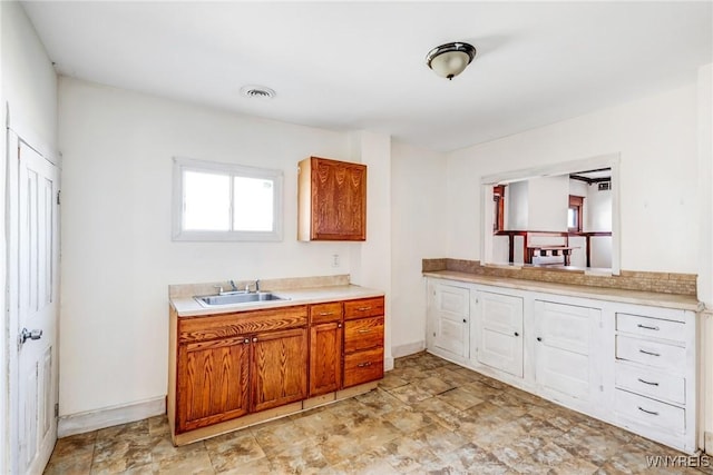 bathroom featuring visible vents, vanity, and baseboards