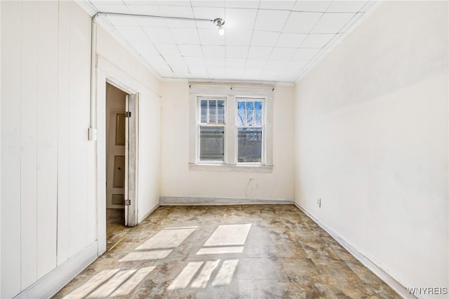 unfurnished room with crown molding