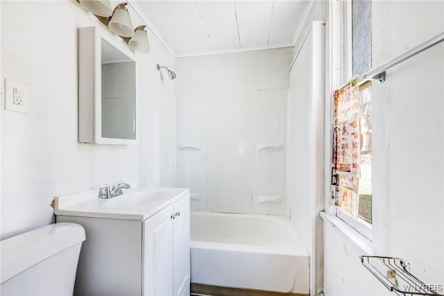 bathroom with toilet, vanity, and washtub / shower combination