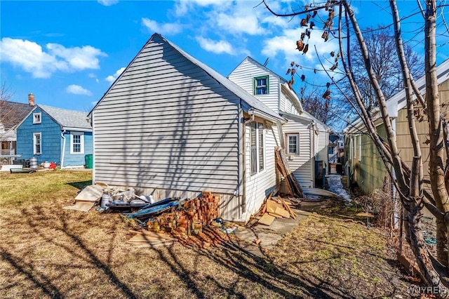 view of property exterior with a yard