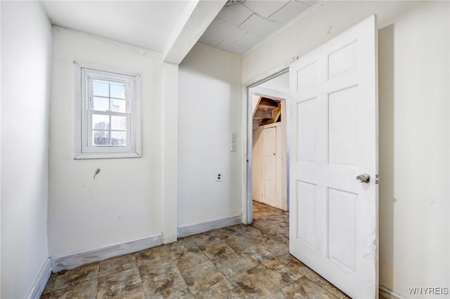 interior space with stone finish flooring and baseboards