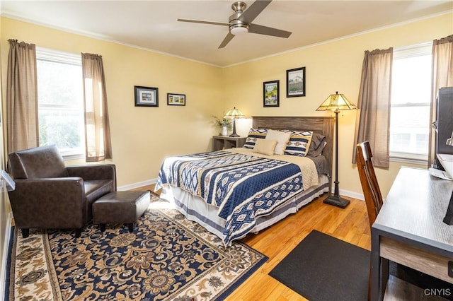 bedroom featuring multiple windows, wood finished floors, and crown molding