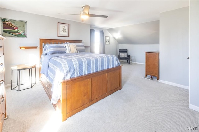 bedroom featuring light carpet, baseboards, lofted ceiling, and a ceiling fan